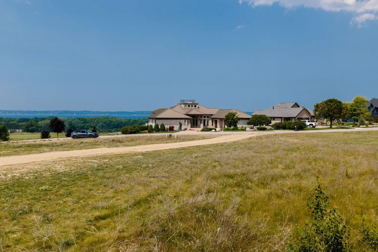 Ground level view from the lot toward homes and bay