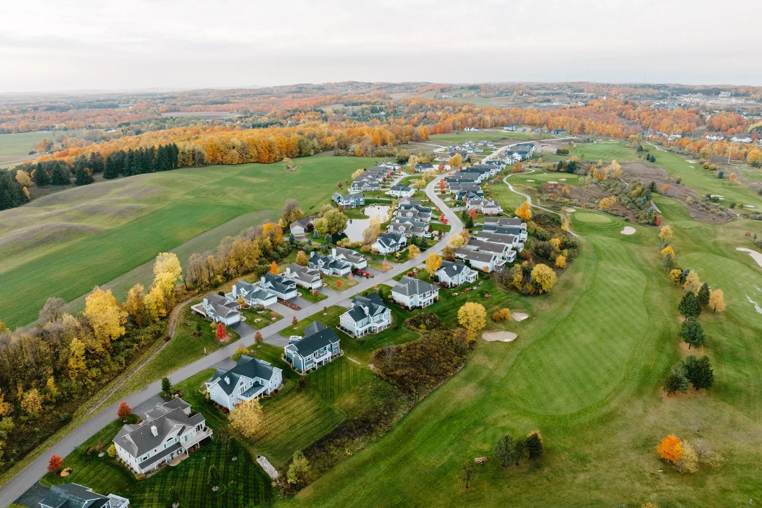 Aerial view of homes at The Crown beside a golf course in Traverse City
