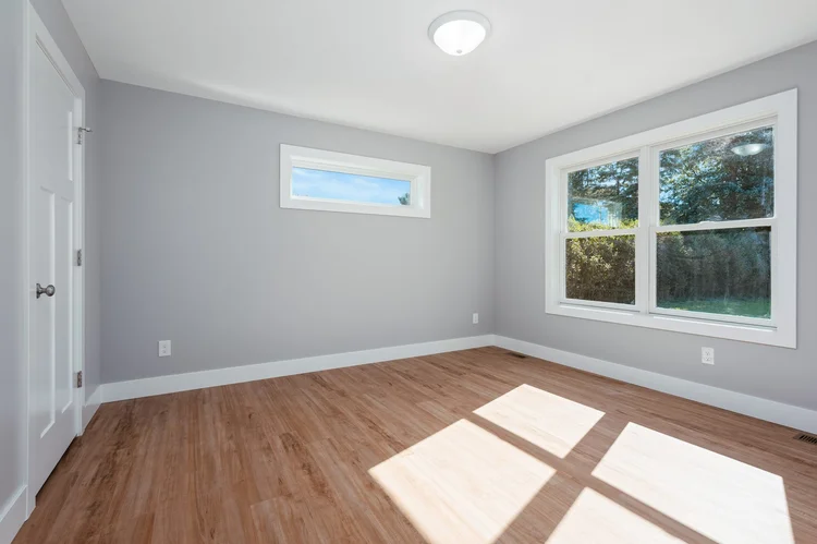 Primary bedroom with large windows