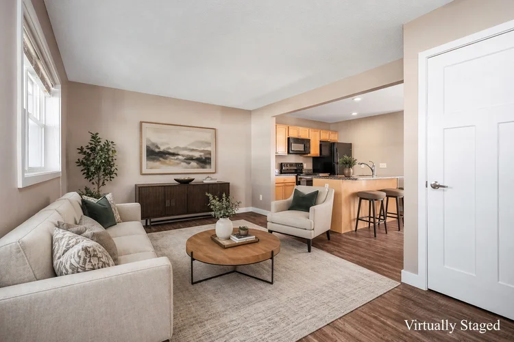 Living room open to the kitchen, virtually staged