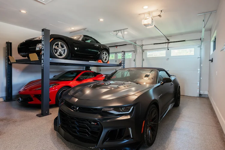 Garage with car lift and three cars