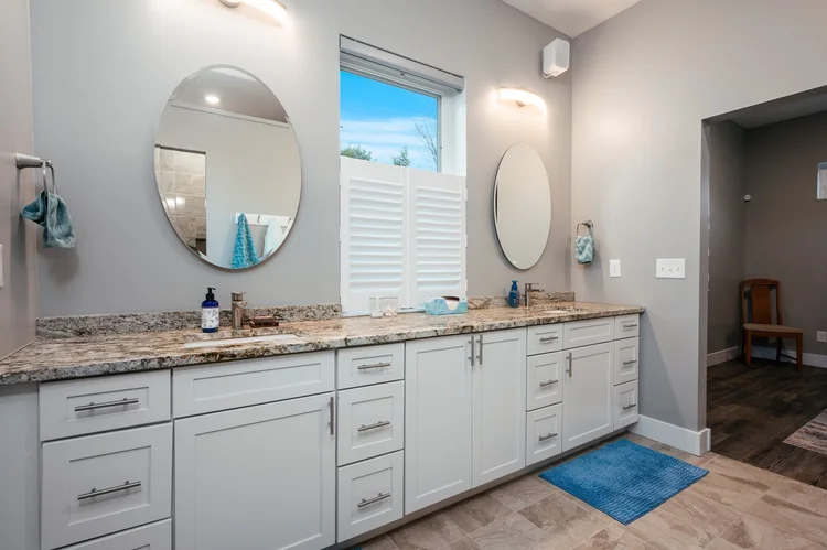 Primary bathroom with long double sink vanity