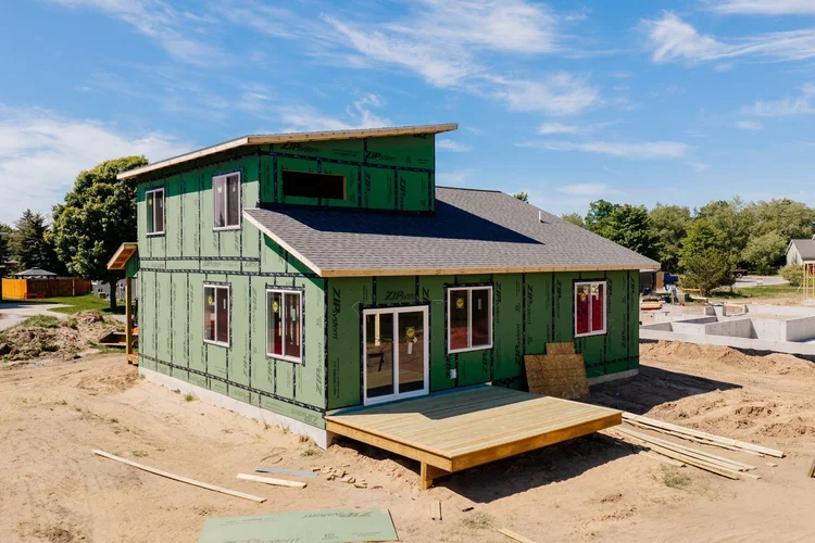 Rear corner of the home with wood deck