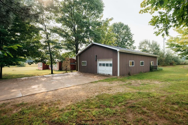 Pole barn with overhead door and driveway