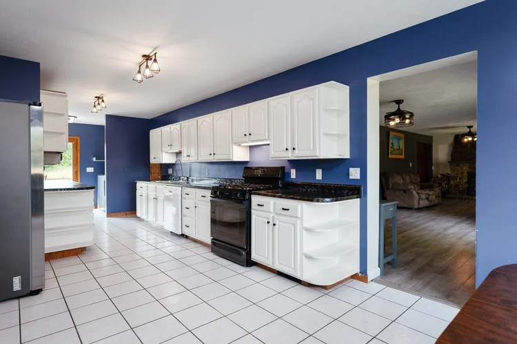 Kitchen with white cabinets and blue walls