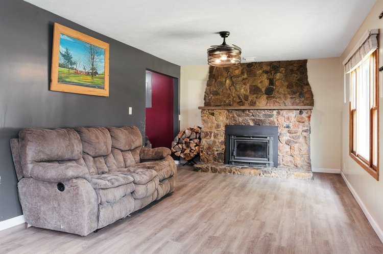 Living room with fieldstone fireplace and wood insert