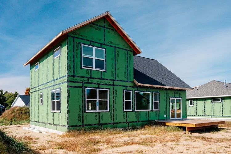 Rear corner of the home with green sheathing