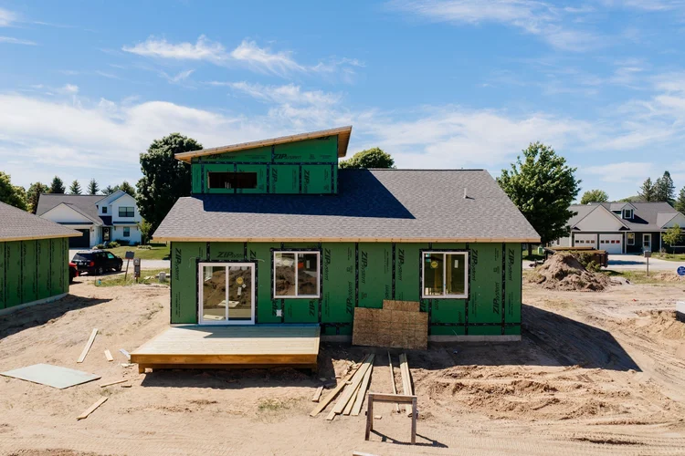 Back of the home with deck and clerestory roof