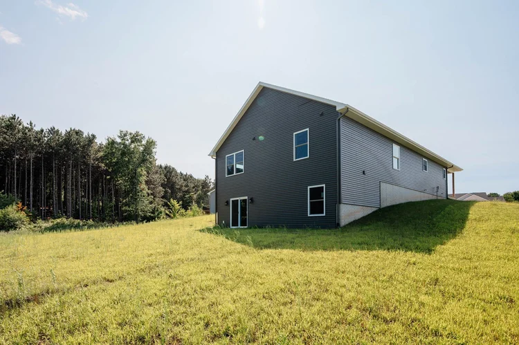 Rear corner of home showing walkout lower level
