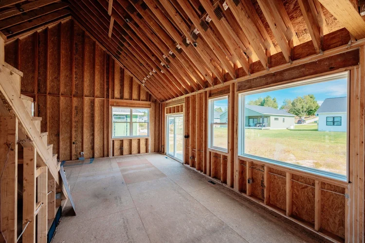 Framed great room with vaulted ceiling and large windows