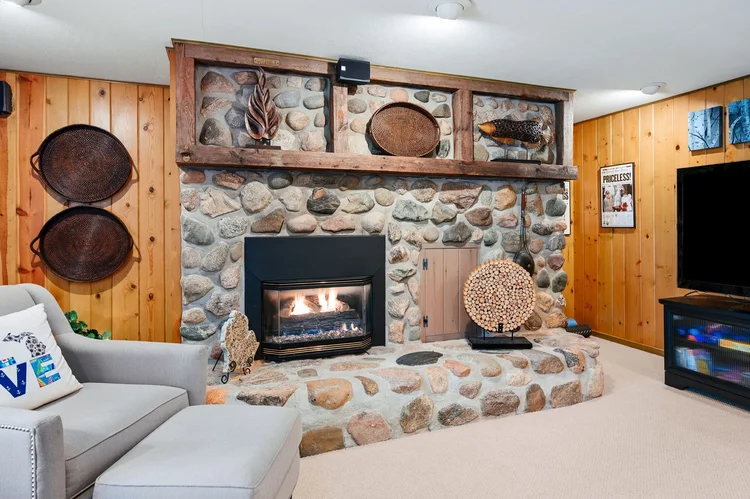Lower level with fieldstone gas fireplace