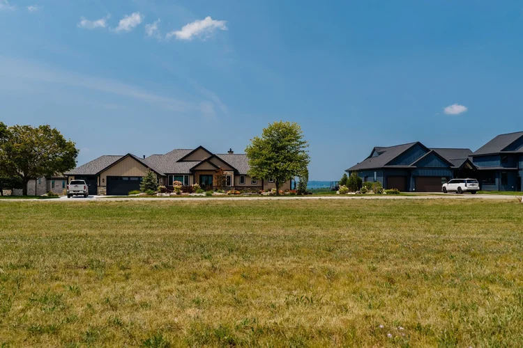 Ground level view across the lot toward neighboring homes