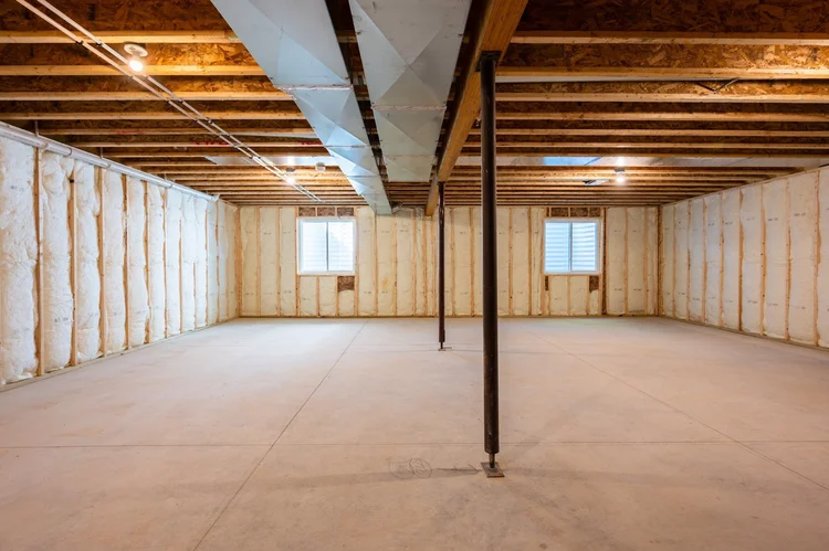 Unfinished basement with insulated walls and two windows