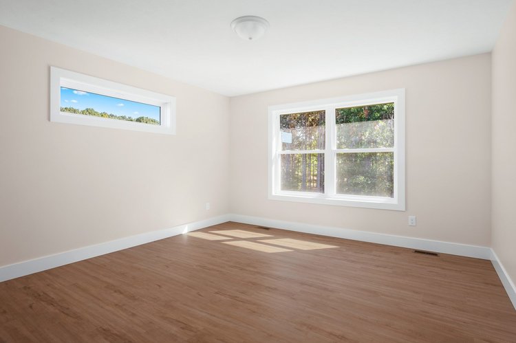 Primary bedroom with double window and transom window