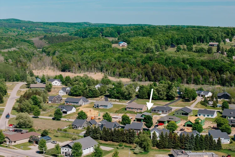 Aerial of the neighborhood with arrow marking the home