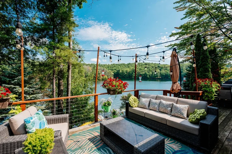 Upper deck with string lights above Chandler Lake