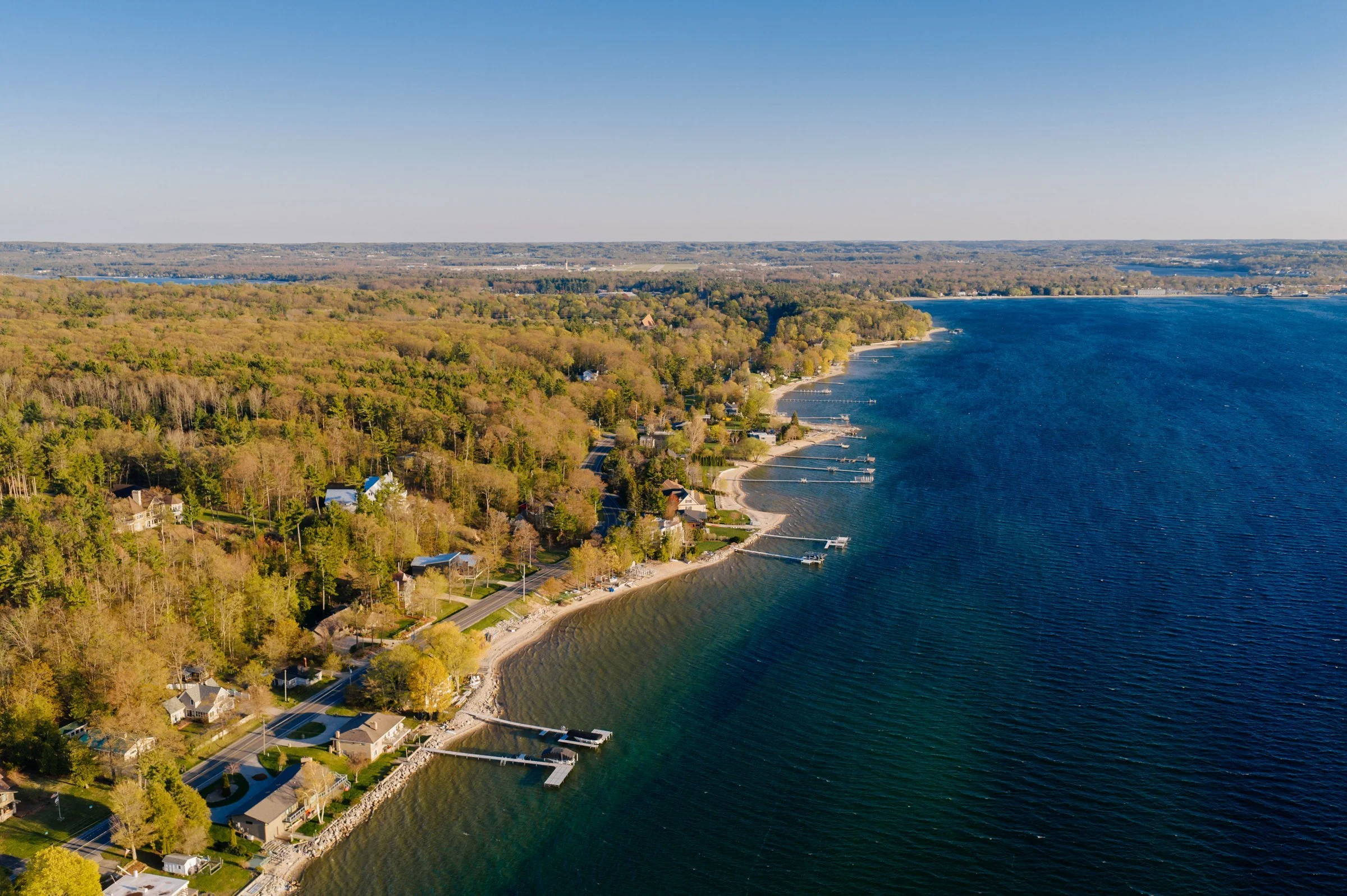 Aerial view of the wooded Old Mission Peninsula shoreline along Grand Traverse Bay