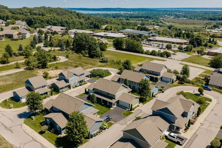 Aerial of the home with the bay in the distance
