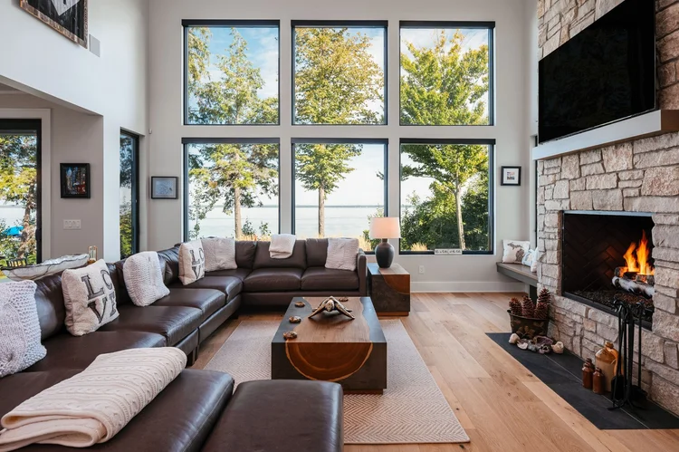 Great room with stone fireplace and tall windows