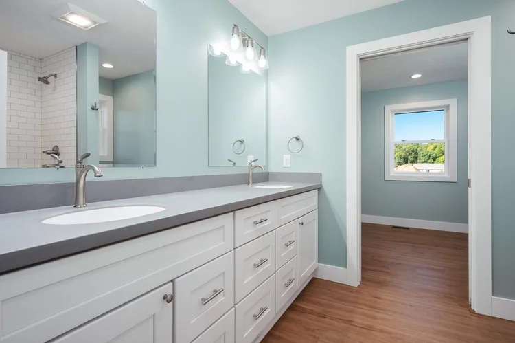 Primary bathroom with double vanity and blue walls