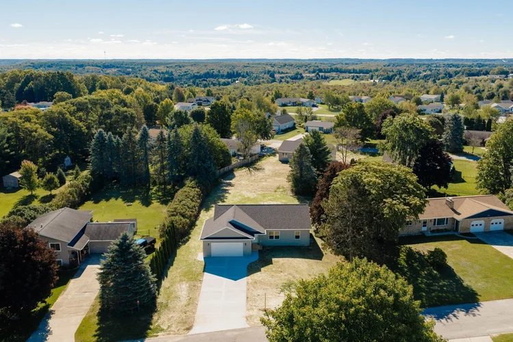 Aerial view of the house and surrounding neighborhood