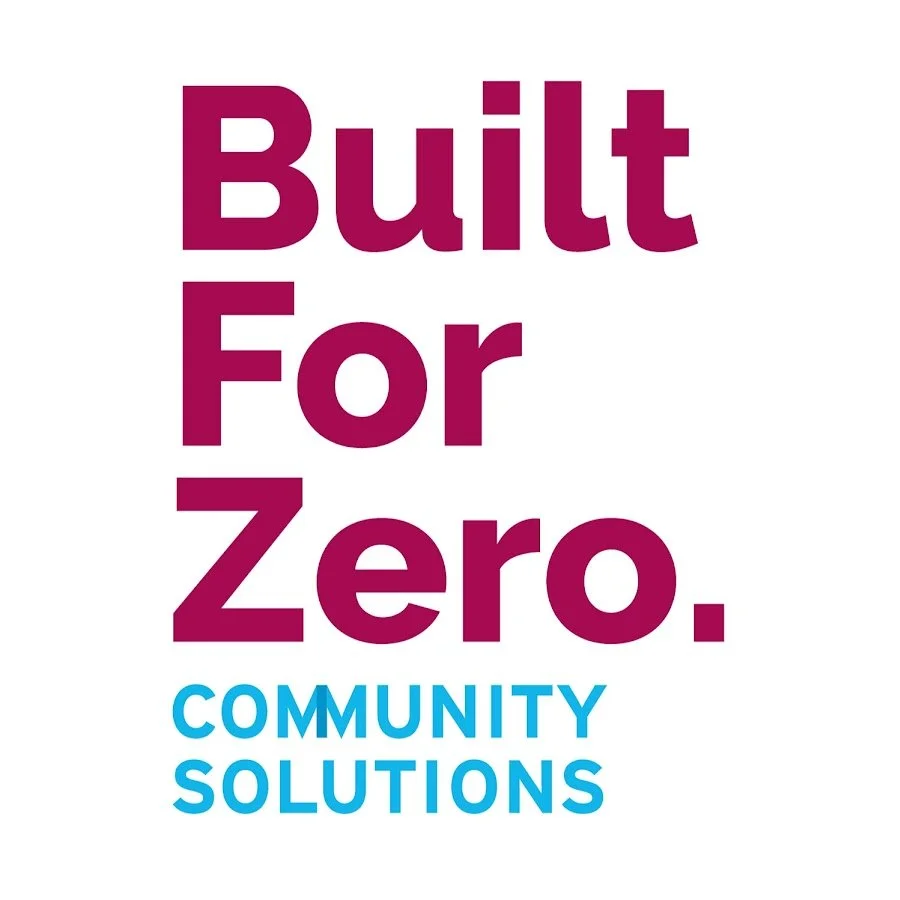 Text reading 'Built For Zero. Community Solutions' in large purple and blue lettering on a white background.