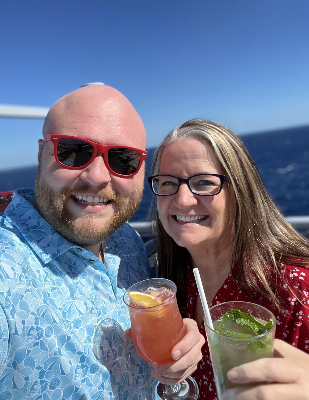 Cody Flowers and Jen Cameron smiling together on a cruise