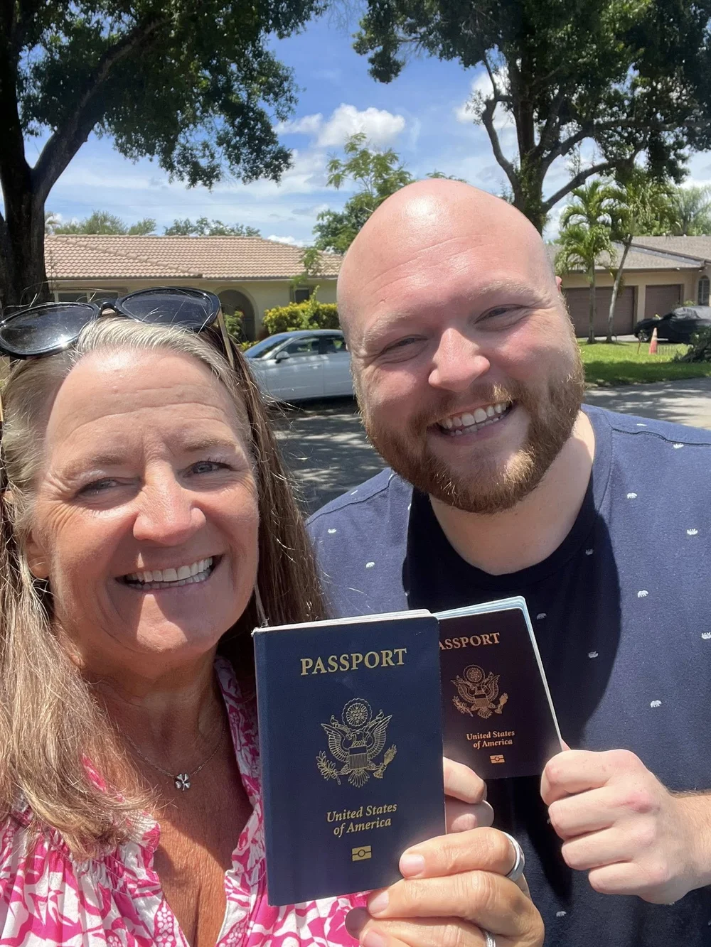 Jen and Cody holding their passports, ready for another adventure