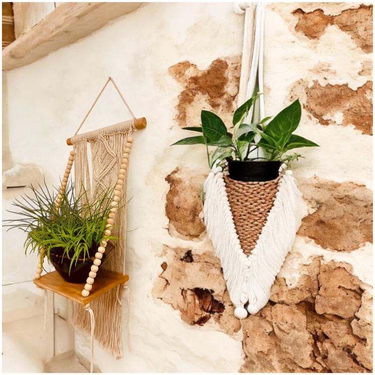 Decorative wall hangs with potted plants on rustic brick and plaster wall