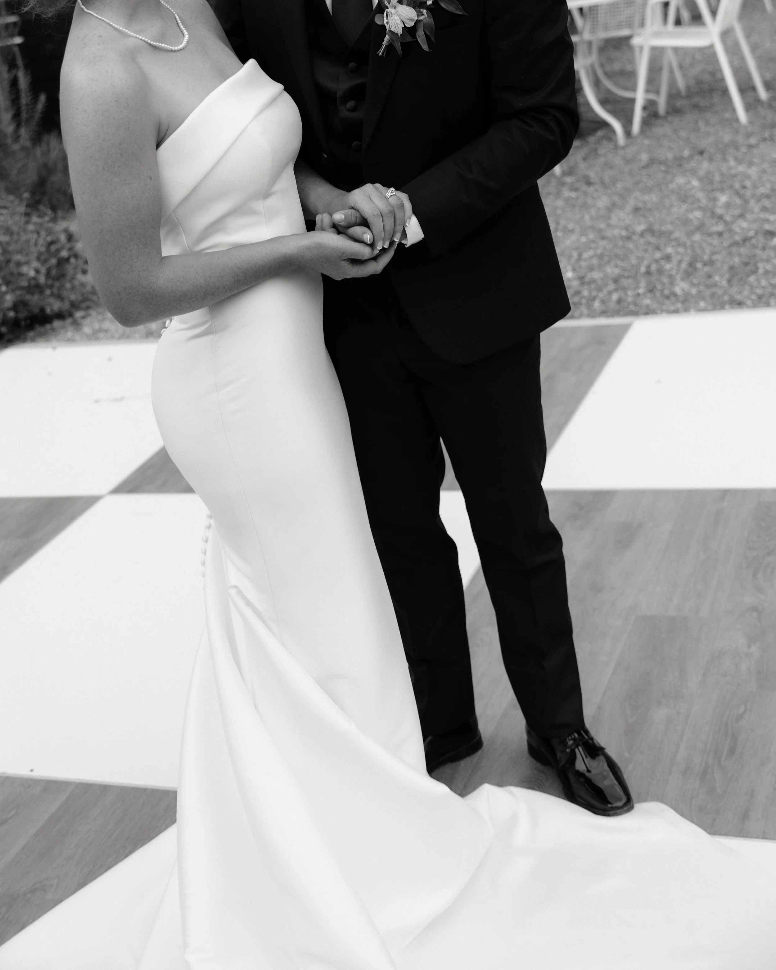 Newlyweds posing for editorial wedding portraits outside the Rosecomb in Chattanooga tn.