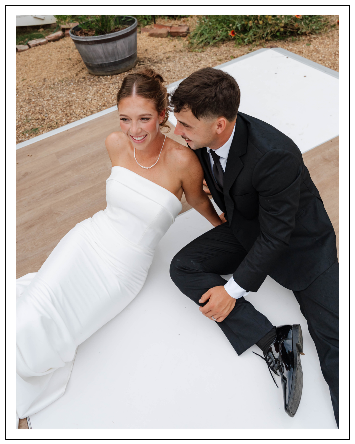 candid bride and groom portraits on checkered dance floor reception space