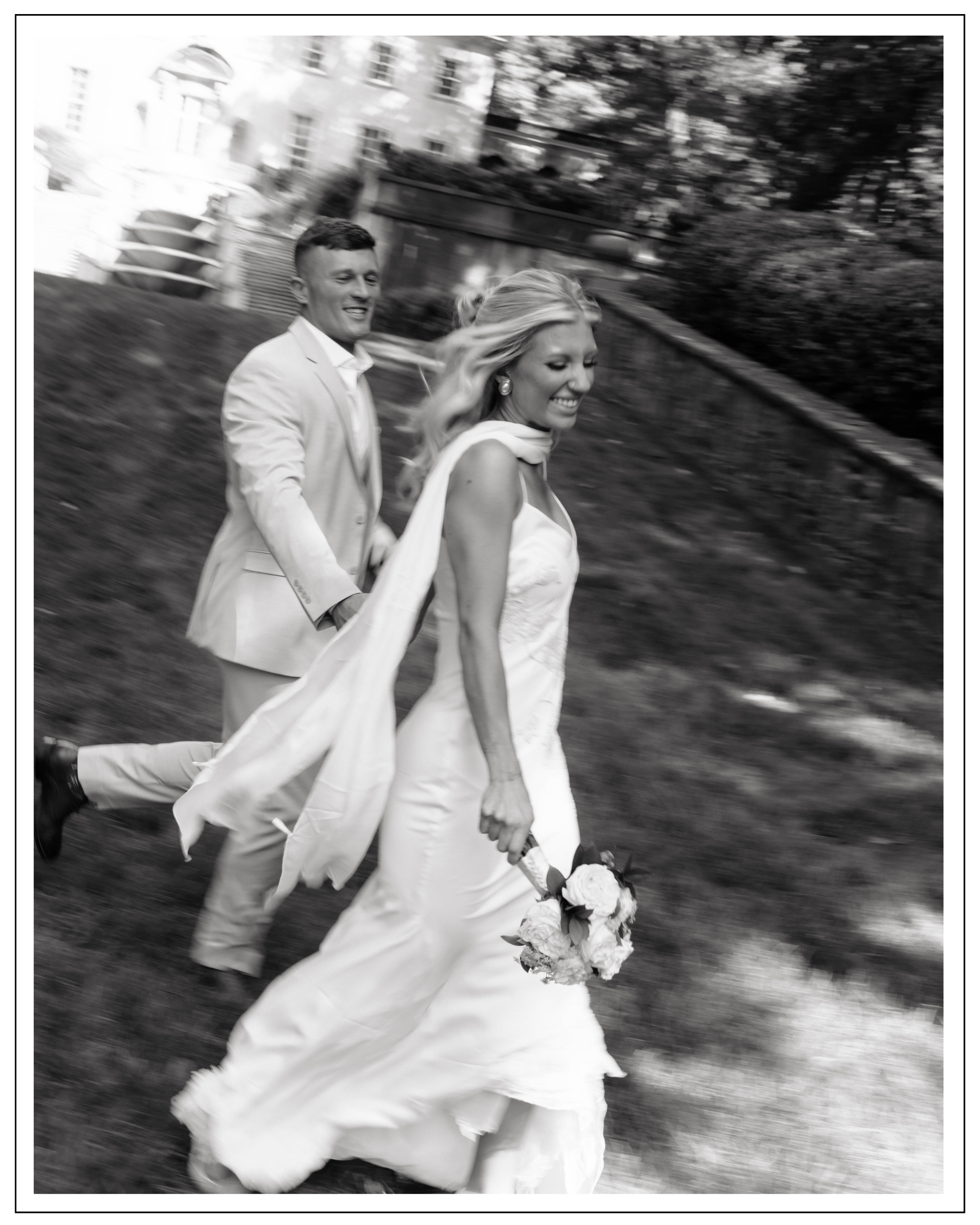 couple running candidly through the grass at the swan house in Atlanta Ga.