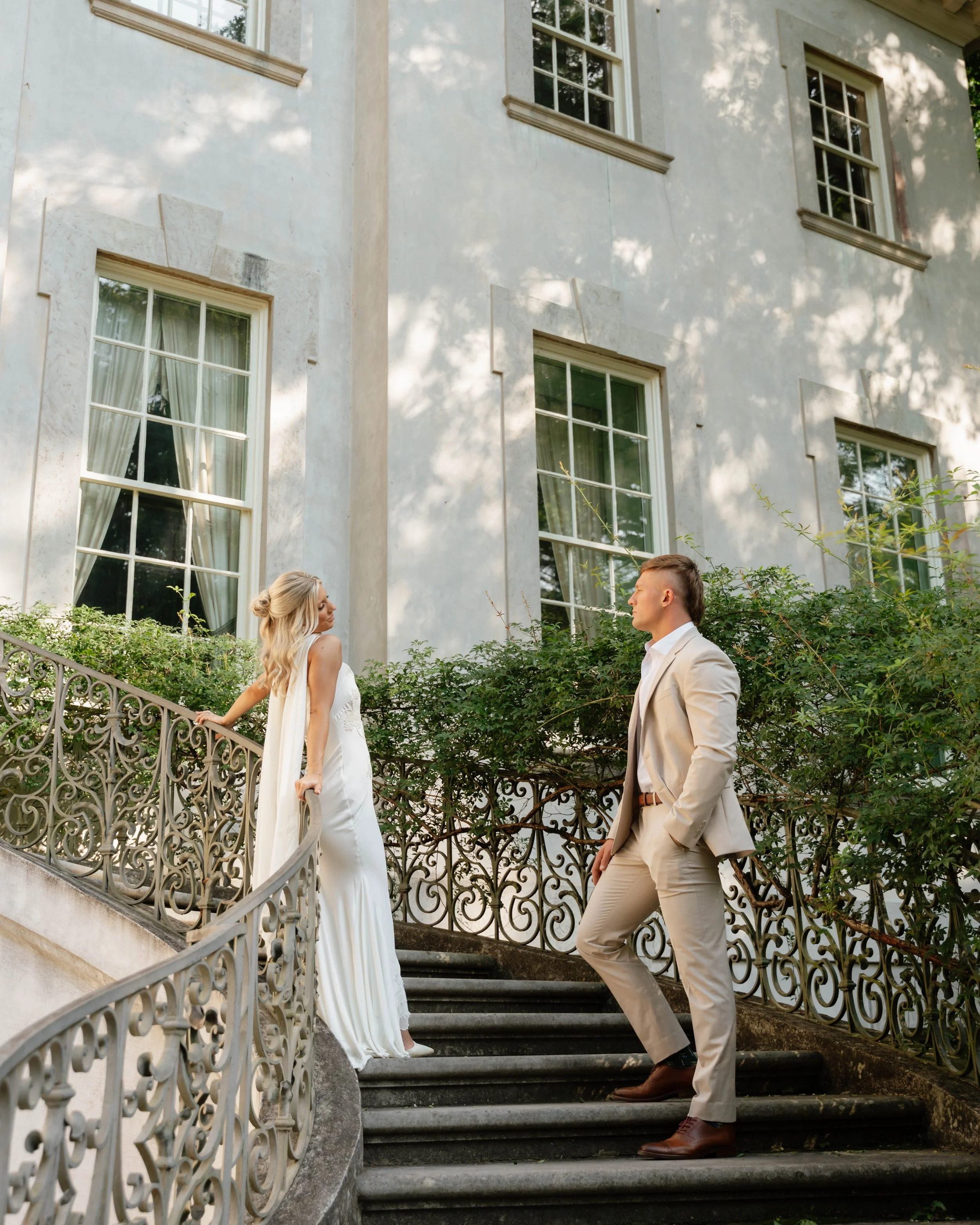 wedding at the Atlanta swan house couple posing separately on a grand staircase outside