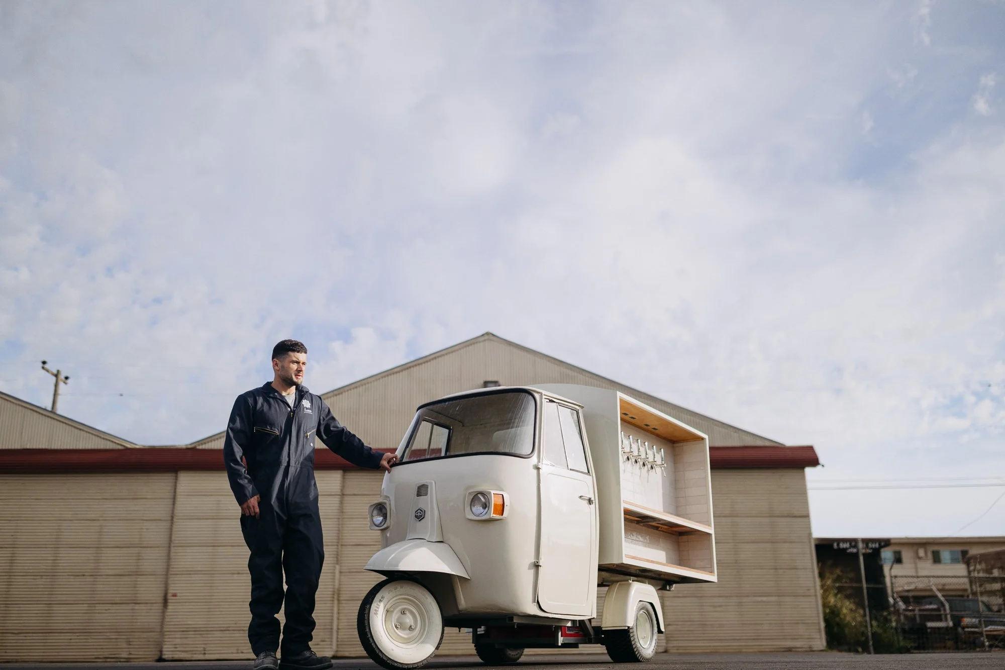 Vintage Piaggio Ape converted into a six-tap mobile bar outside the Lusso Vivo workshop
