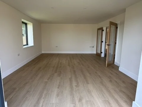 Empty room. Wooden flooring, bi fold doors