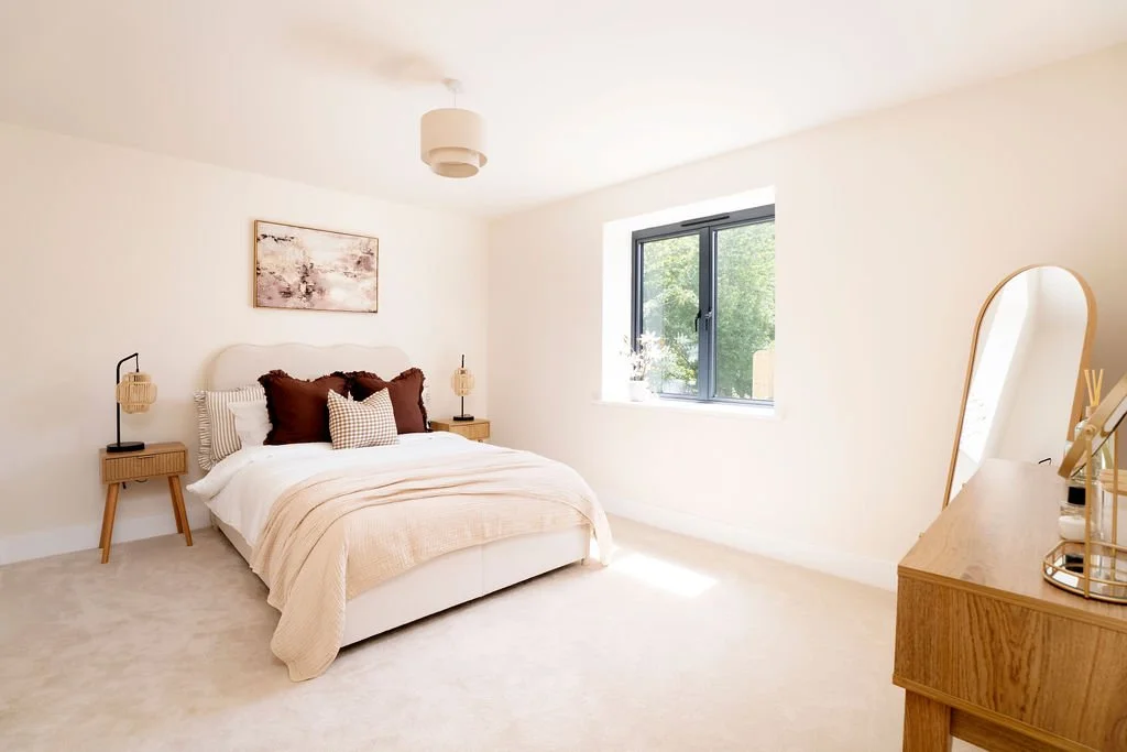 Warm bedroom design. Beige headboard, brown cushions & bedspread. Wood console table