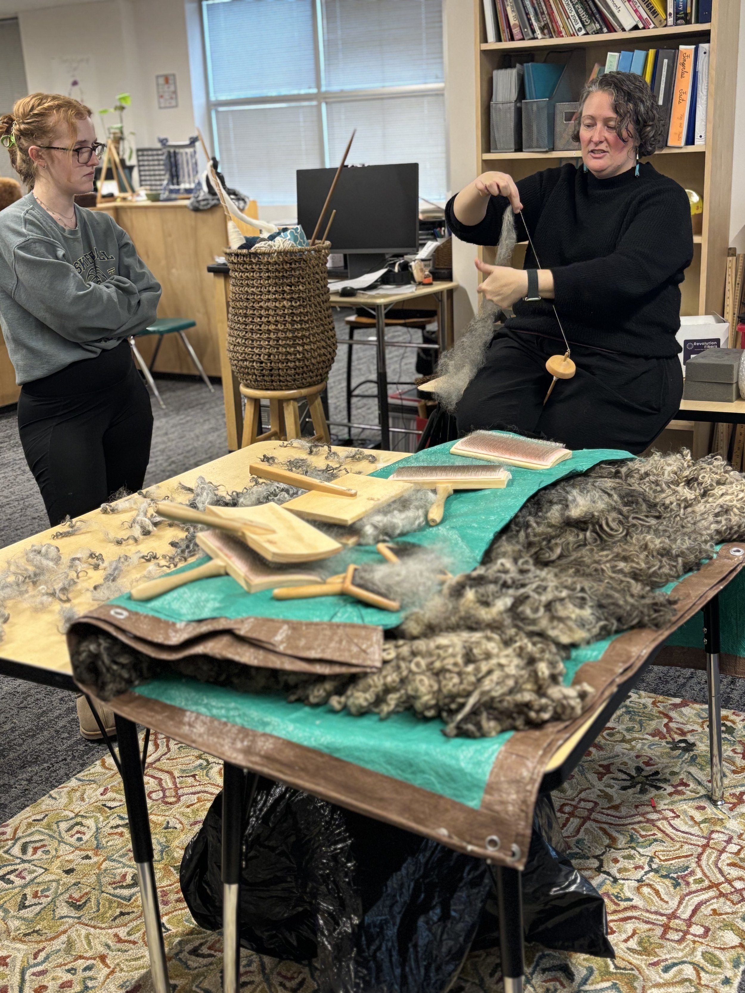 teacher demonsrates spindle to a student