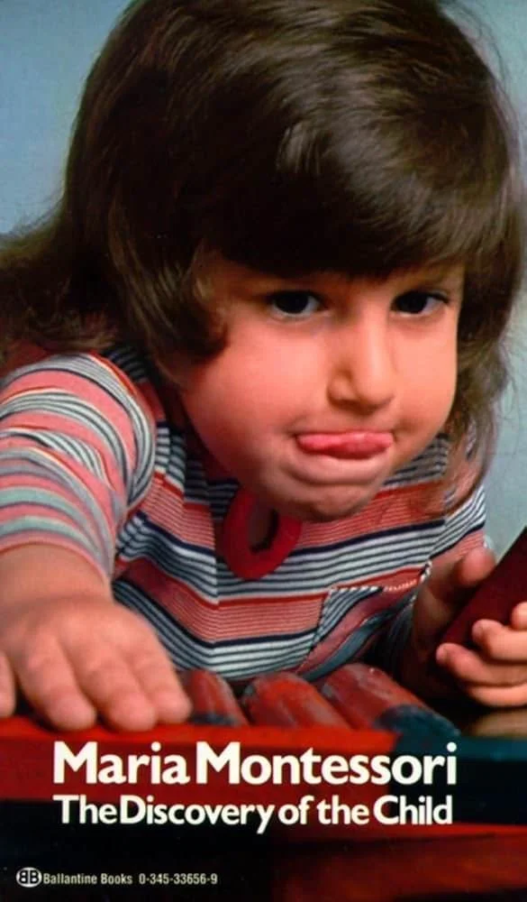 Book cover titled "Maria Montessori: The Discovery of the Child" by Ballantine Books, featuring a young girl with brown hair, wearing a striped shirt, reaching towards the camera with a playful expression.