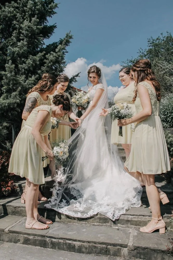 Lightweight lace edge cathedral veil draping gracefully, romantic long bridal veil complementing lace wedding gown.