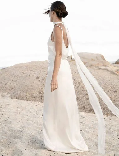 Bride wearing simple neck scarf veil draped effortlessly, chic and versatile, reflecting 2026 wedding veil trends.
