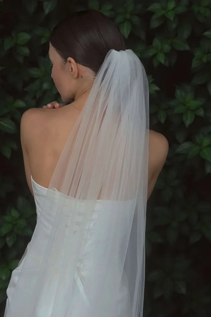 Back view of simple cathedral length single layer wedding veil on modern bride, lightweight soft Swiss tulle bridal veil.