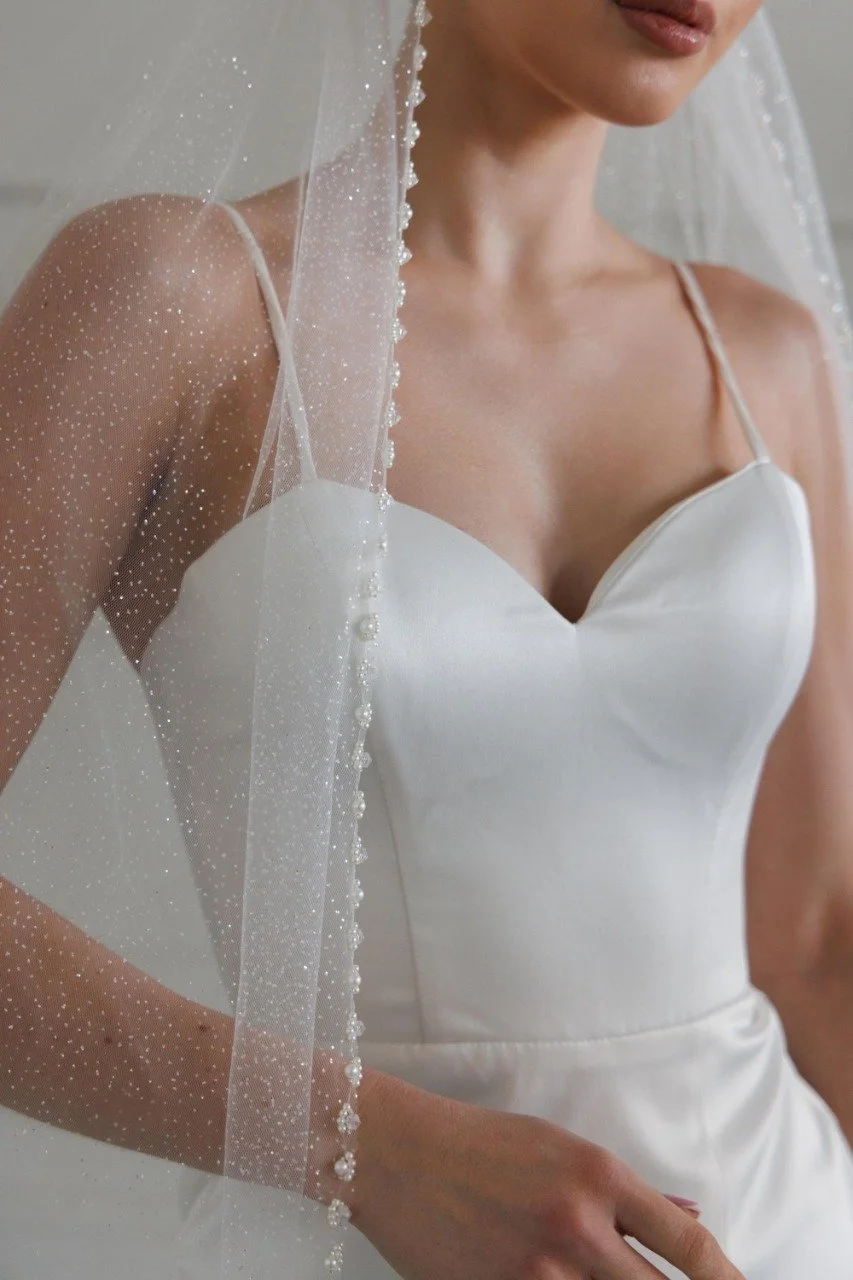 Glitter tulle fabric close-up showing delicate shimmer of wedding veil