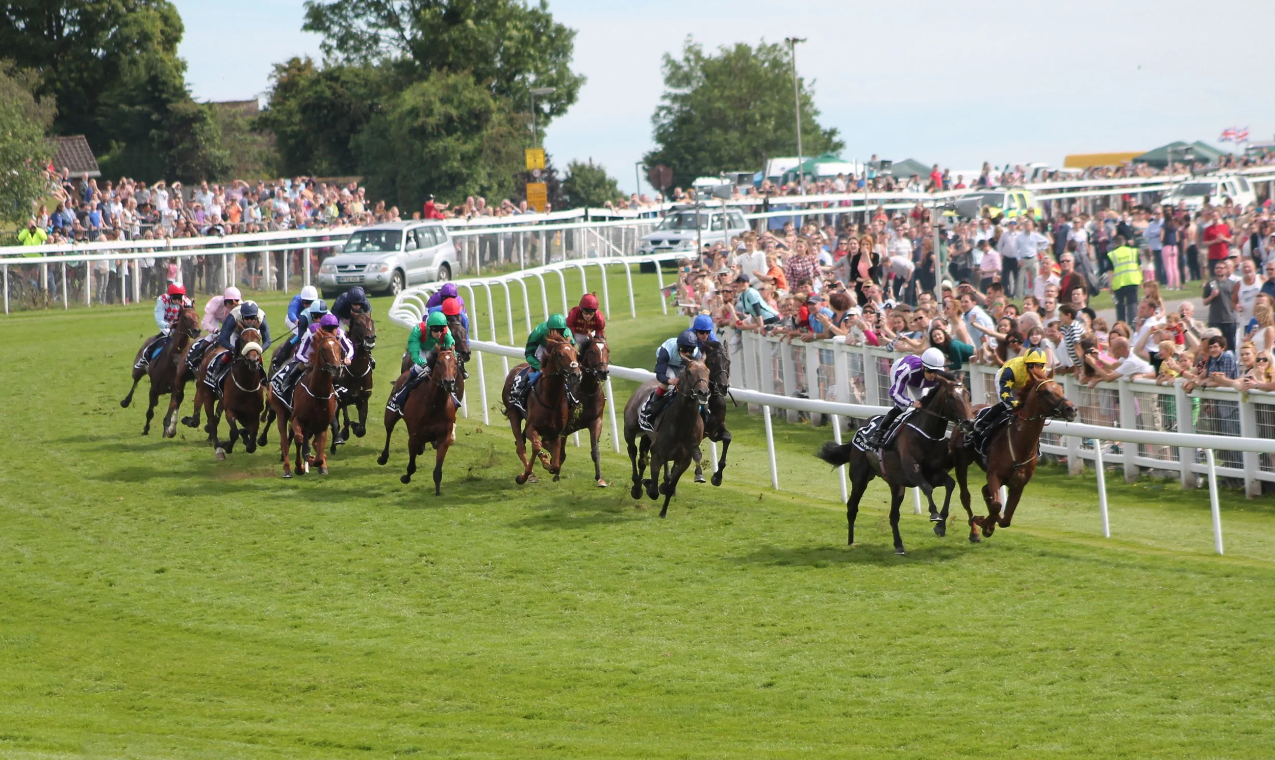 Bet the 2026 Epsom Derby Festival at MyWinners — horses rounding Tattenham Corner at Epsom Downs, the most famous bend in British Flat racing