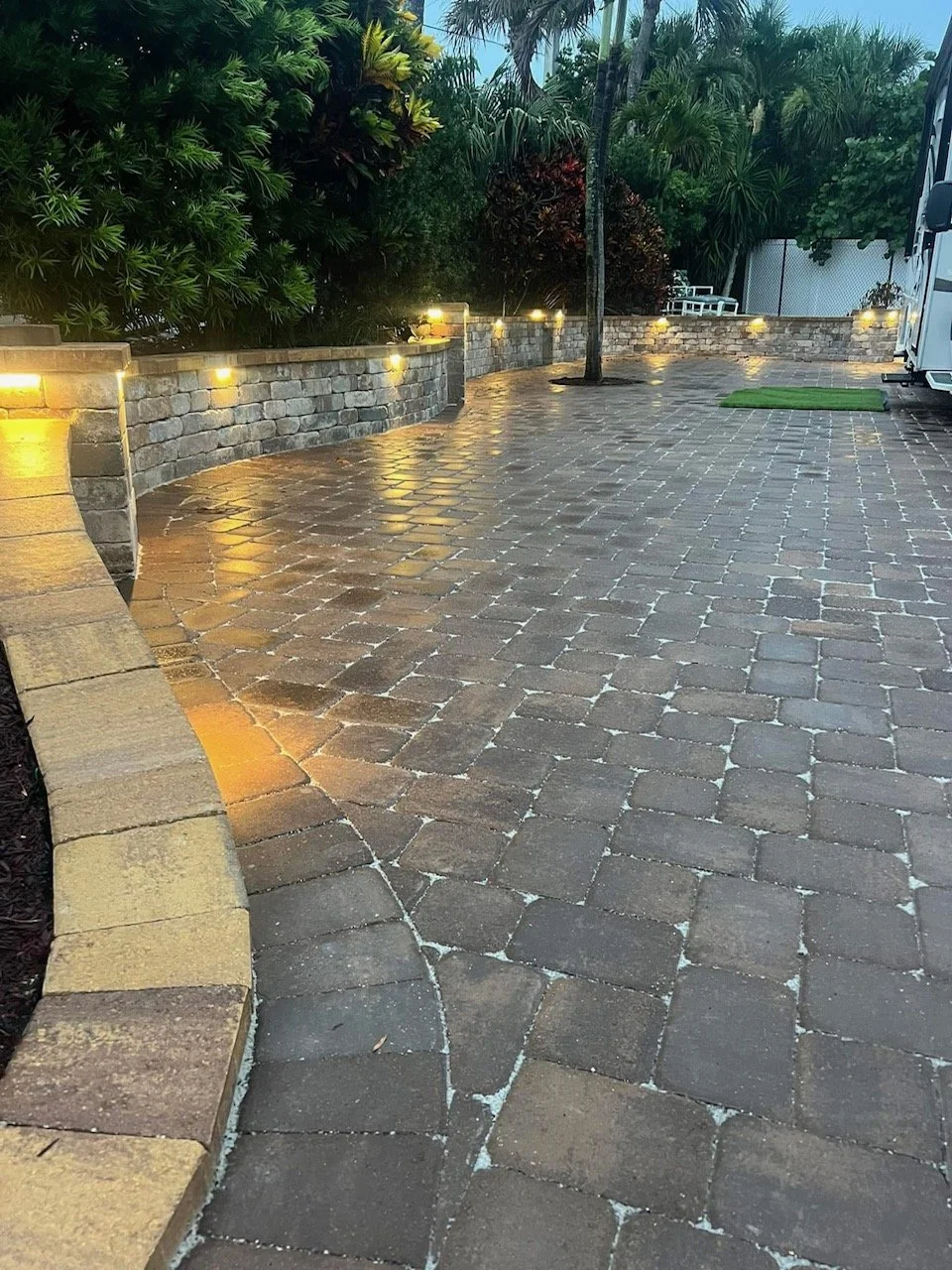 Hardscape contractor serving Brevard County with custom paver driveways, pool decks, patios, walkways, retaining walls, seating walls, outdoor kitchens, fire pits, drainage systems, concrete work, and landscape enhancements.