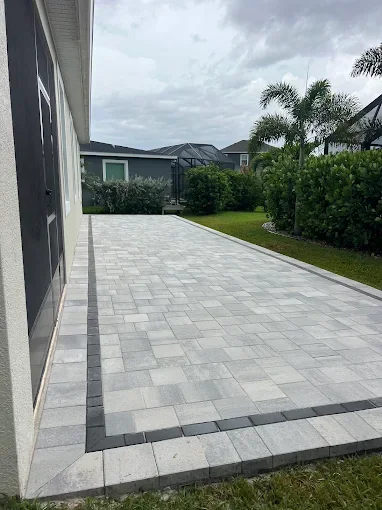 Melbourne and Palm Bay outdoor living contractor providing paver patios, pool decks, driveways, walkways, outdoor kitchens, fire pits, retaining walls, drainage solutions, concrete installation, decorative rock, and artificial turf.