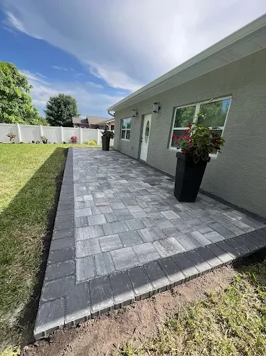 Outdoor living contractor serving Brevard County with paver driveways, patios, pool decks, retaining walls, artificial turf, concrete and drainage services.