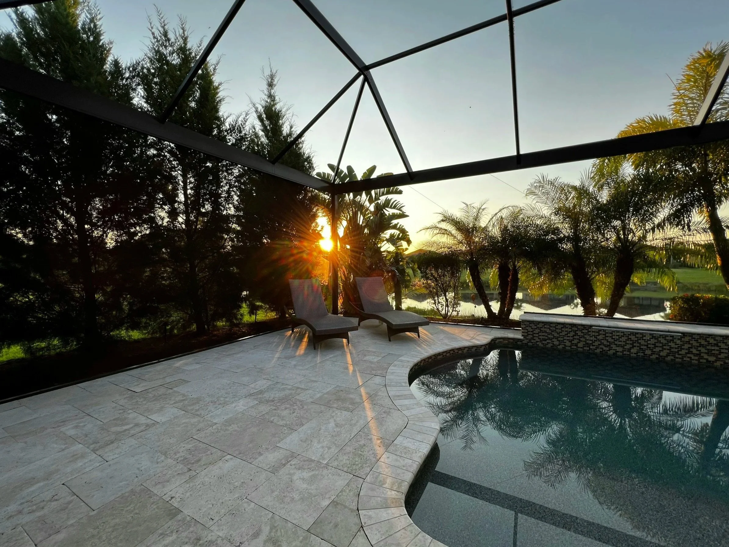 Luxury pool deck renovation in Satellite Beach, Florida, featuring premium pavers and expert installation that complements the surrounding outdoor environment.