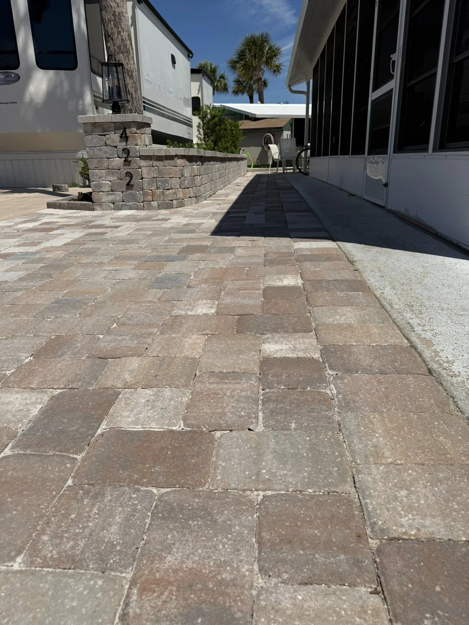 Brevard County paver contractor specializing in paver driveways, patios, pool decks, walkways, retaining walls, outdoor kitchens, fire pits, concrete driveways, concrete patios, drainage correction, decorative rock installation, artificial turf
