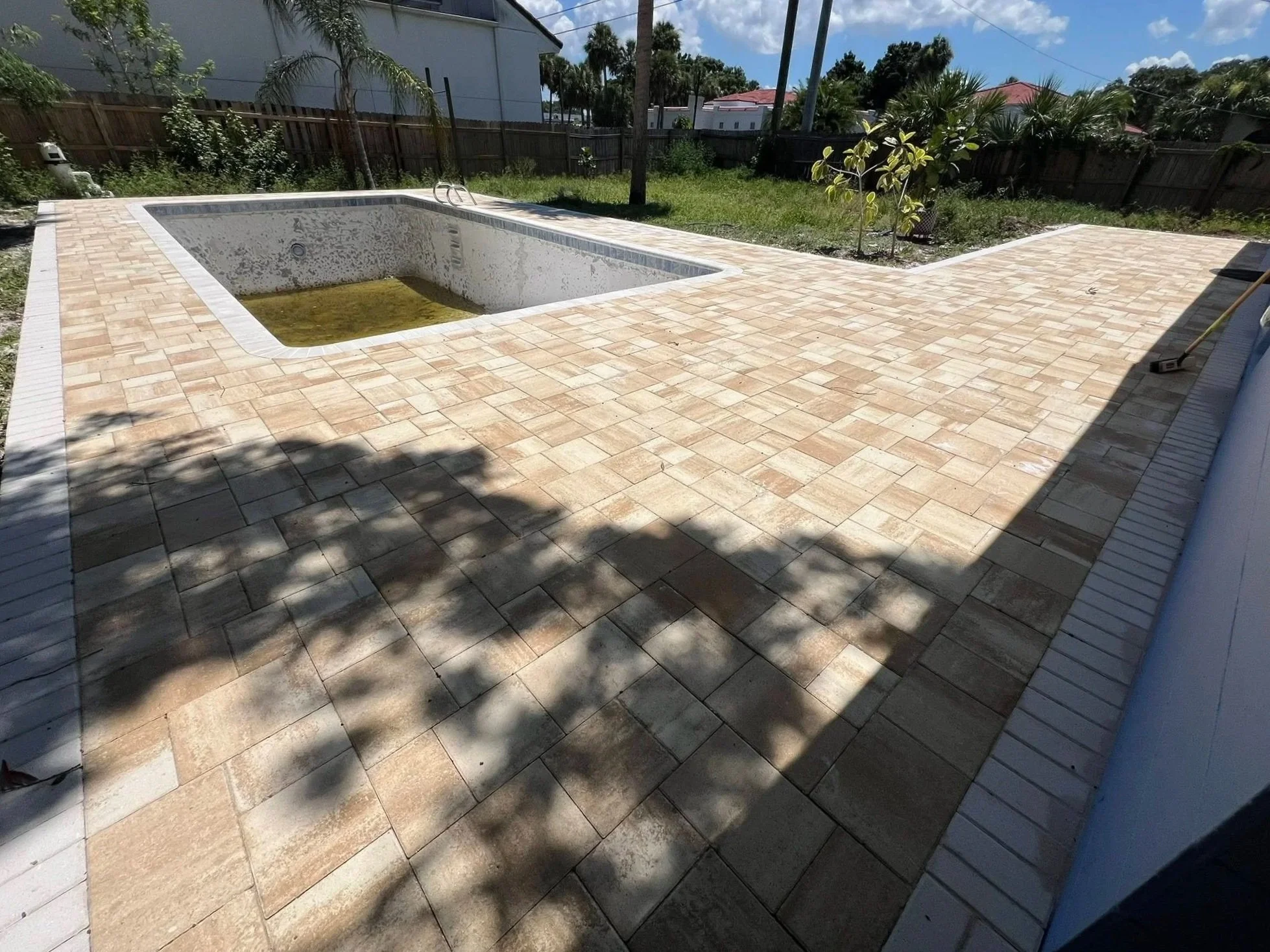 Brevard County paver contractor specializing in paver driveways, patios, pool decks, walkways, retaining walls, outdoor kitchens, fire pits, concrete driveways, concrete patios, drainage correction, decorative rock installation, artificial turf
