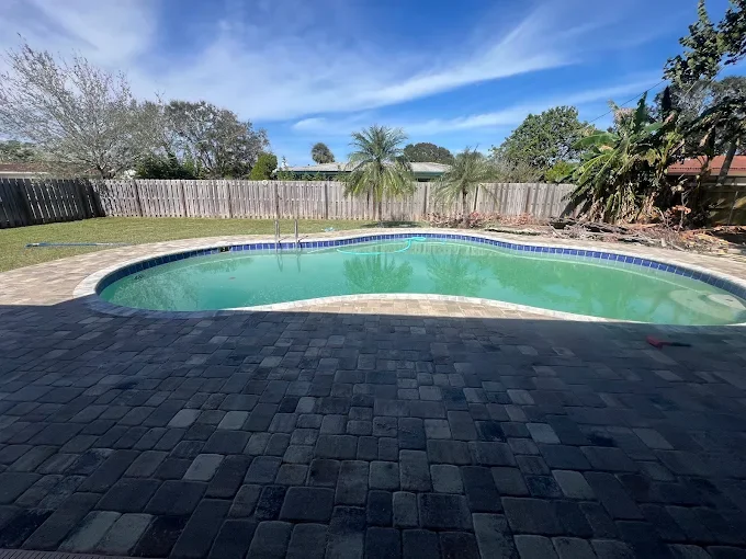 Hardscape contractor serving Brevard County with custom paver driveways, pool decks, patios, walkways, retaining walls, seating walls, outdoor kitchens, fire pits, drainage systems, concrete work, and landscape enhancements.